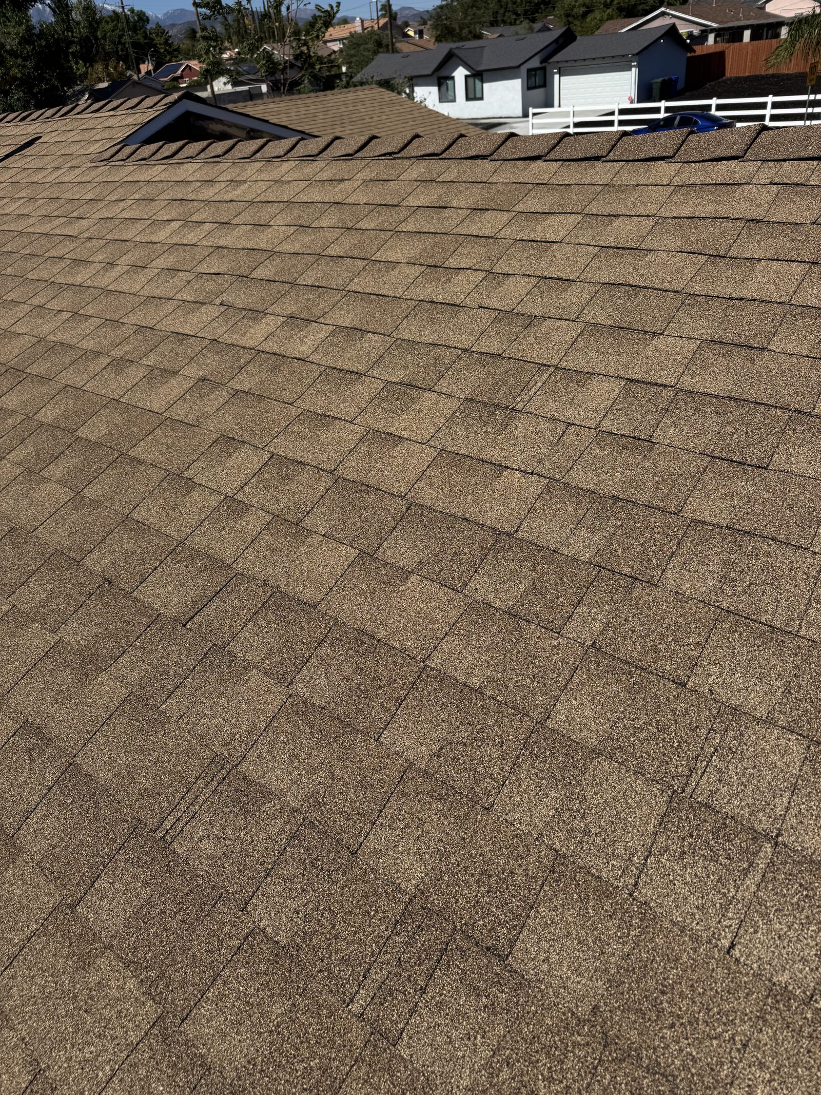 Completed shingle roof with neighborhood view